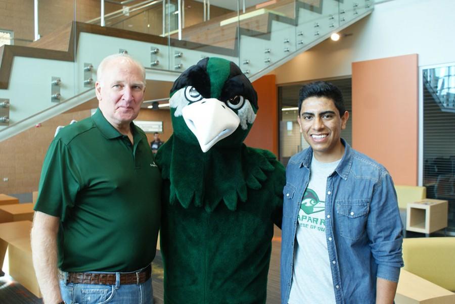 College of DuPage President Robert L. Breuder, left, poses with Chappy and student Trustee Omar Escamilla, right.