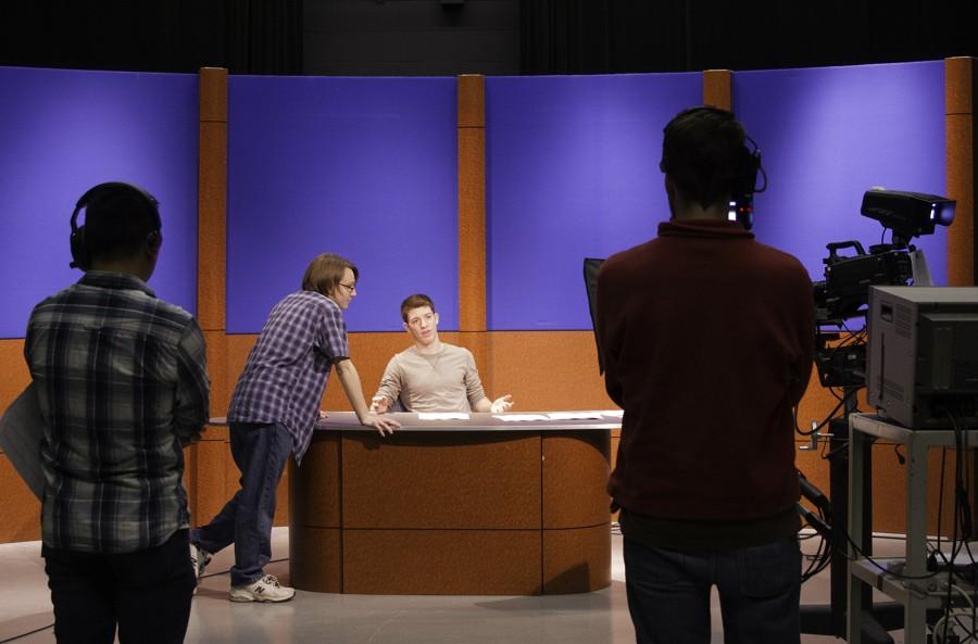 Students Collin Flakus, Taylor Joes and Tim Goulding prepare a news broadcast featuring Mitch Miller in May 2014 for Introduction to TV Studio Production in MAC Room 187.