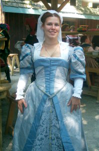 Melissa Heischberg wearing a Grey Middle Class Kirtle and Gown in a Renaissance fair.