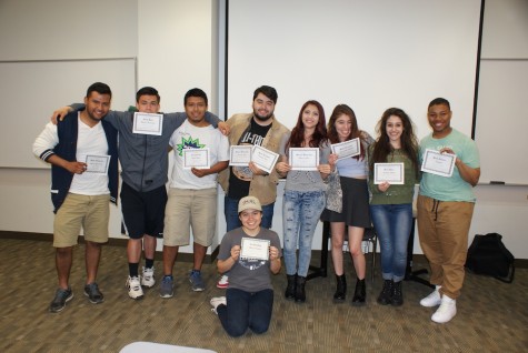 Students pose with certificates during a LEAA meeting. LEAA, a student group on campus, aims to connect the growing Latino student population.