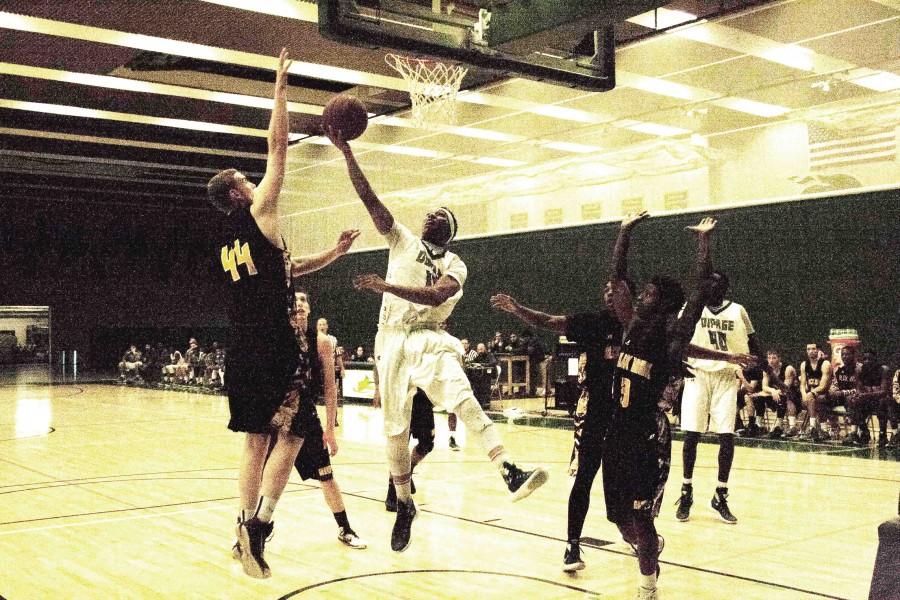 Chaparral guard #12 Anthony Taylor attempting a layup past Black Hawk-Moline forward in a match at the College of DuPage on Dec. 5.