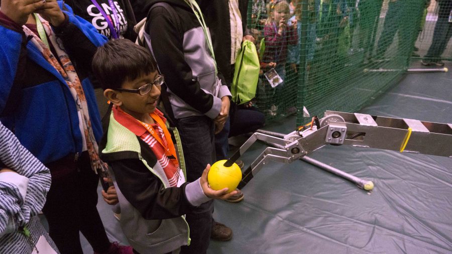COD Engineering Club robot handing a ball to an audience member.