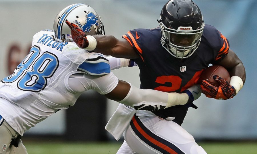 CHICAGO, IL - OCTOBER 02: Jordan Howard #24 of the Chicago Bears tries to break away from Devin Taylor #98 of the Detroit Lions at Soldier Field on October 2, 2016 in Chicago, Illinois.  (Photo by Jonathan Daniel/Getty Images)