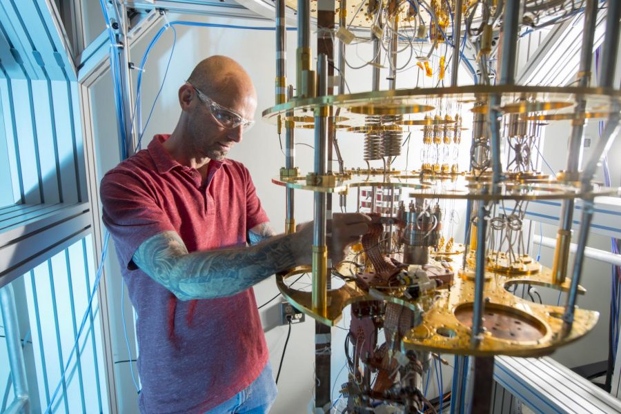 Physicist Damon Bice works on a quantum dilution refrigerator at Fermilab National Laboratory. The lab hopes their research inspires the evolving quantum computing industry (photo provided by Fermilab)