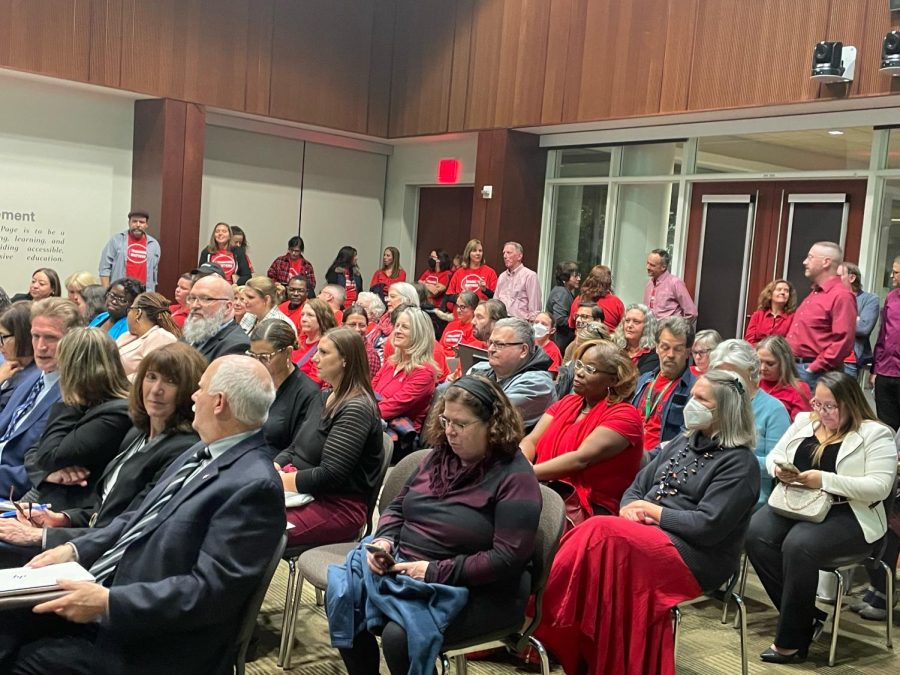 Faculty dressed in red at the board meeting. 