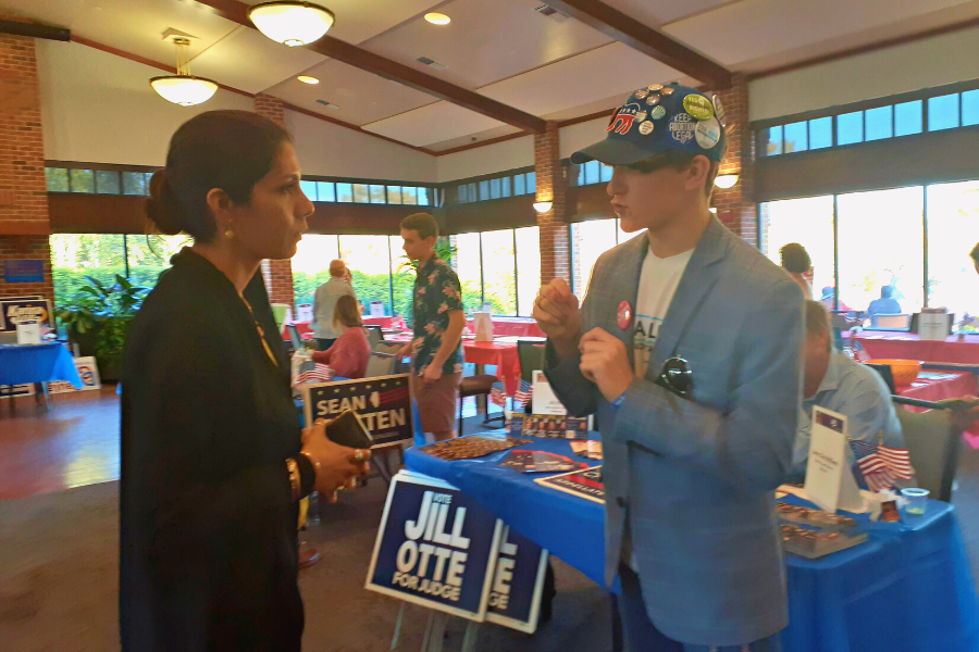 Eric Willoughby talks to Saba Haider, a candidate for DuPage County Board.
(Photo by Mariyam Syed)