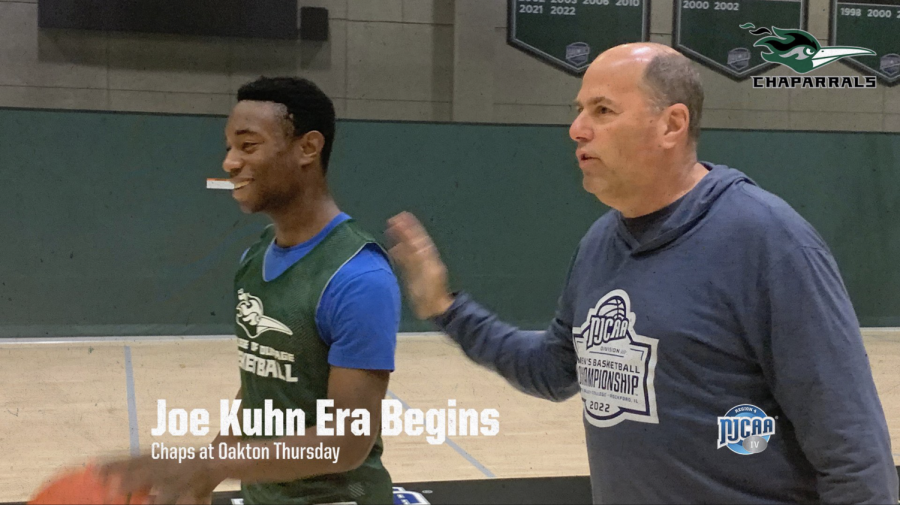 Head+Coach+Joe+Kuhn+leads+player+Drew+Gaston+at+practice.+