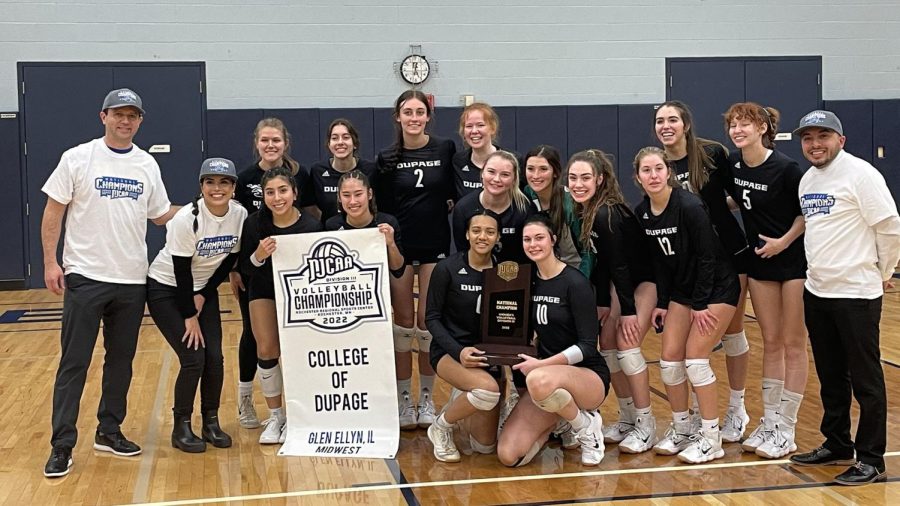 The womens volleyball team poses on the court for their national victory. 