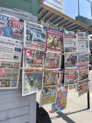 Newsstand depicting different headlines: "Counted days," "Faces of Violence," "Police and Military Alerted."