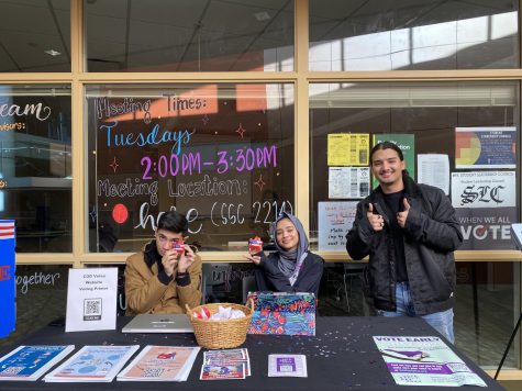 A photo of Luis Medina with students at a COD Votes booth.