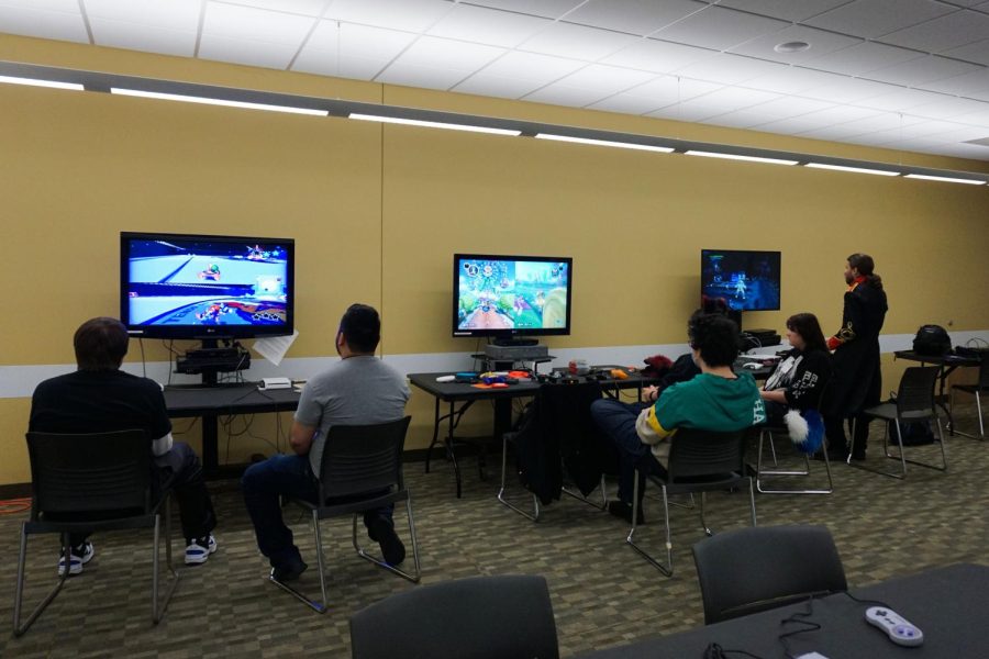 CONCOD attendees enjoying their time playing video games. 
