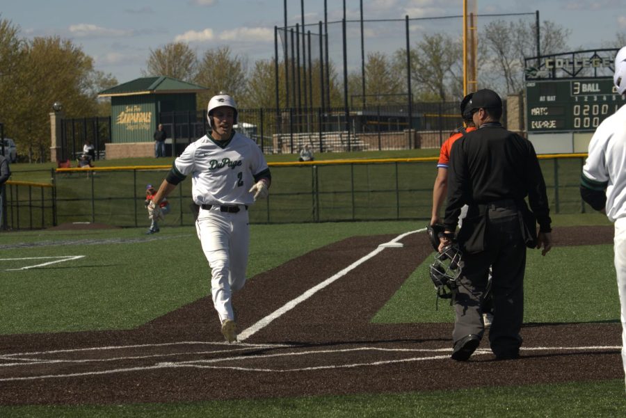 Sophomore outfielder Kyle Fenner sprints to cross home plate and score a run. 