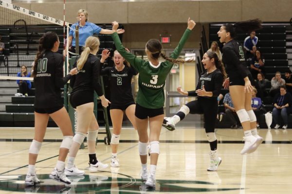 Members of COD volleyball celebrate after scoring a point. 
