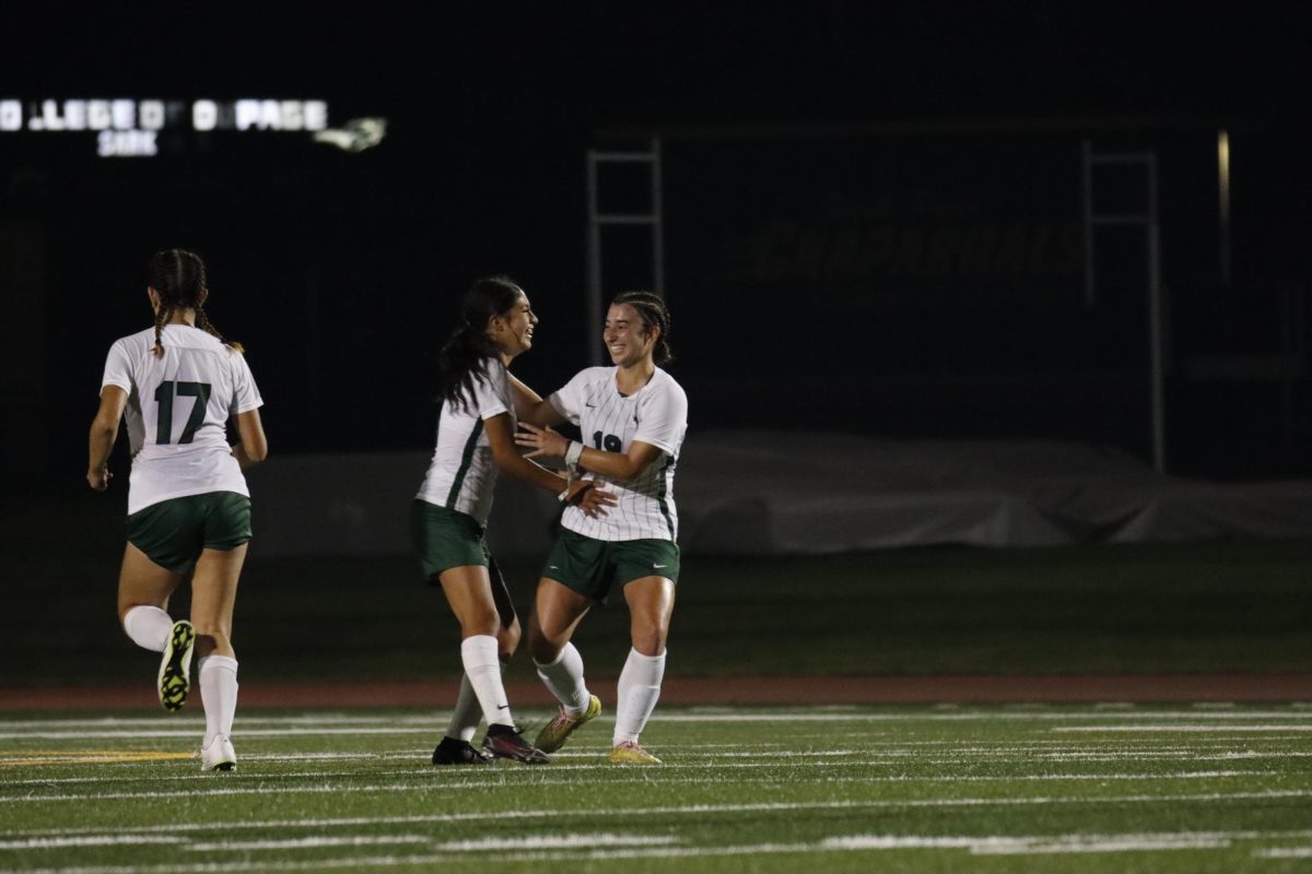 Sophomore Anna Odisho and Freshman Kim Martinez celebrate together after scoring the third goal of the night