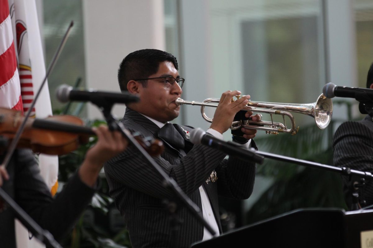 A member of Mariachi Monumental de México performs a solo on trumpet. 