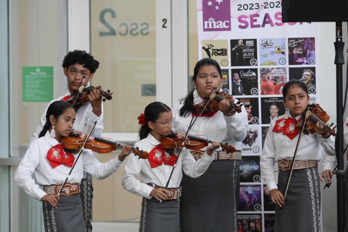 Students from Mariachi los Pumas de Jovita Idár Elementary play on the violin. 