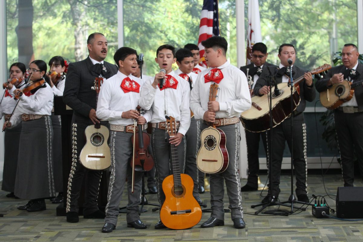 A trio of young students from Mariachi los Pumas de Jovita Idár Elementary perform a song.