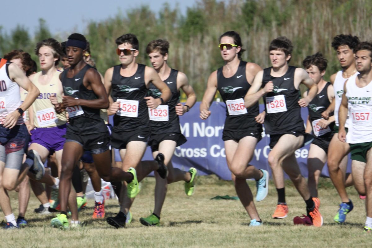 The men’s cross-country team sprints from the starting line. They placed fifth out of nine teams with 123 points.
