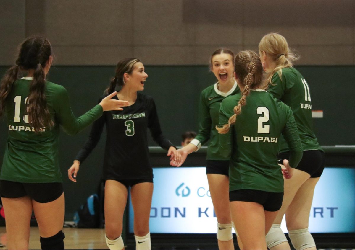 COD womens volleyball players celebrate after earning a point. 