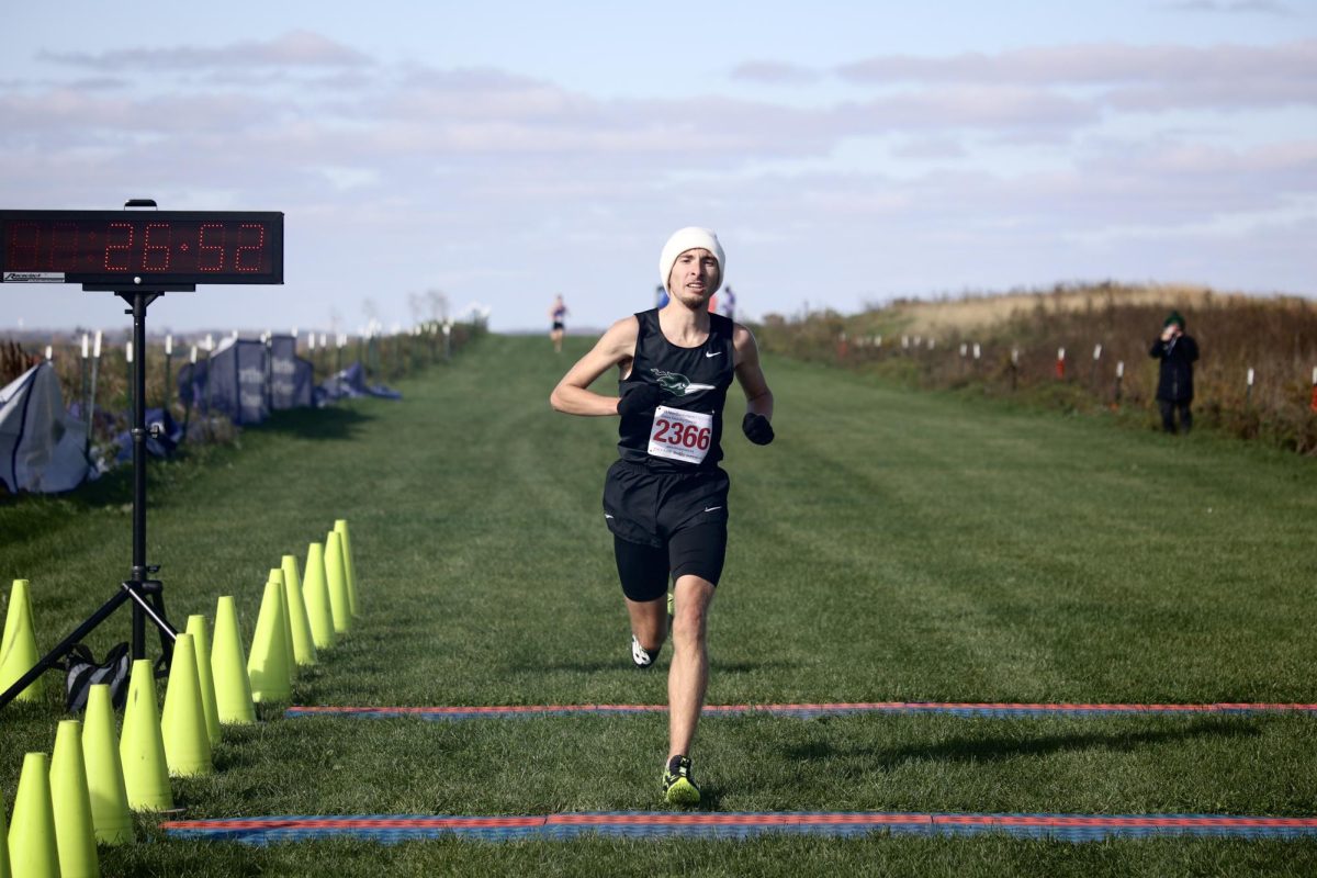 Freshman Kevin Diederich crosses the finish line in 26:51.50, winning the region four cross country title. 