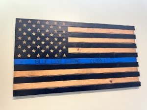 A Blue Line flag plaque displayed above the memorial for fallen Bloomingdale, Ill. police officer Raymond Murrell. 
