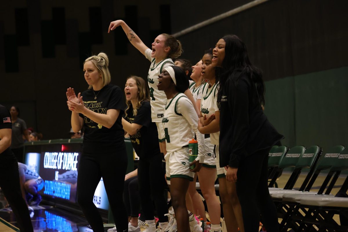 The COD womens basketball team celebrates after scoring.