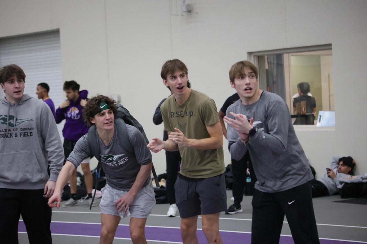 The COD track team cheers for their teammates during the 4x400 meter relay. 