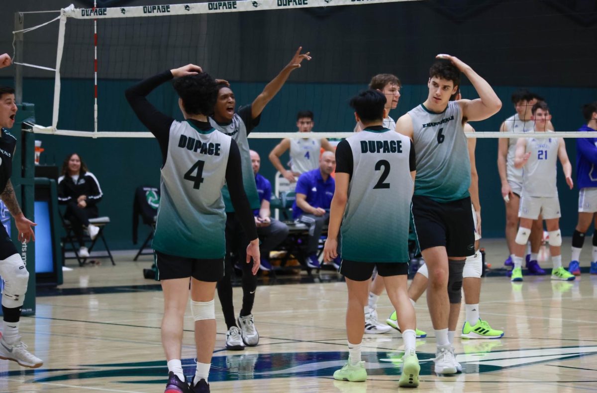 The COD mens volleyball team celebrates after scoring a point.