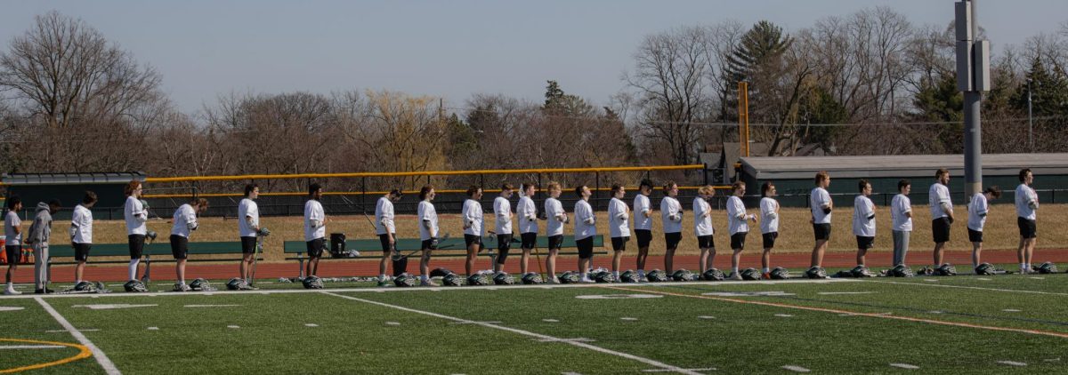 The COD mens lacrosse team lines up before the national anthem. 