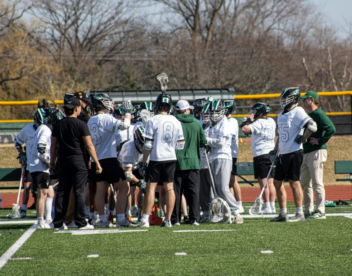 The COD mens lacrosse team huddle after the win against HCCC.