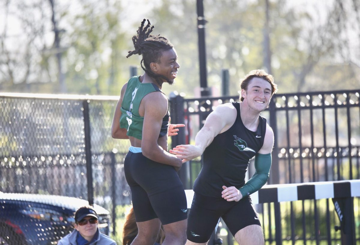 Freshmen Tim McMiller and Weston White celebrate after going 1-2 in the 100-meter dash. 