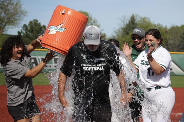 Team manager Raquel Procopio dumps water on head softball coach Barry Froehle. 
