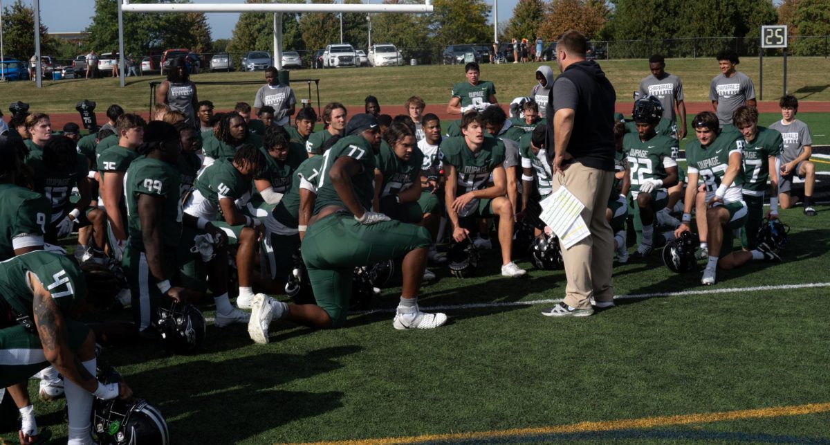 The COD football team huddles after the game. 