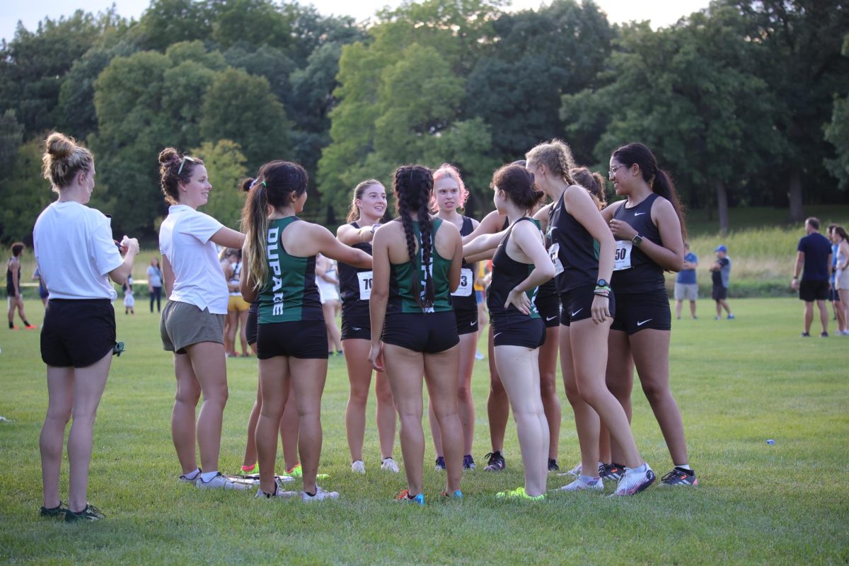 The COD women's cross country team huddle before the race. 