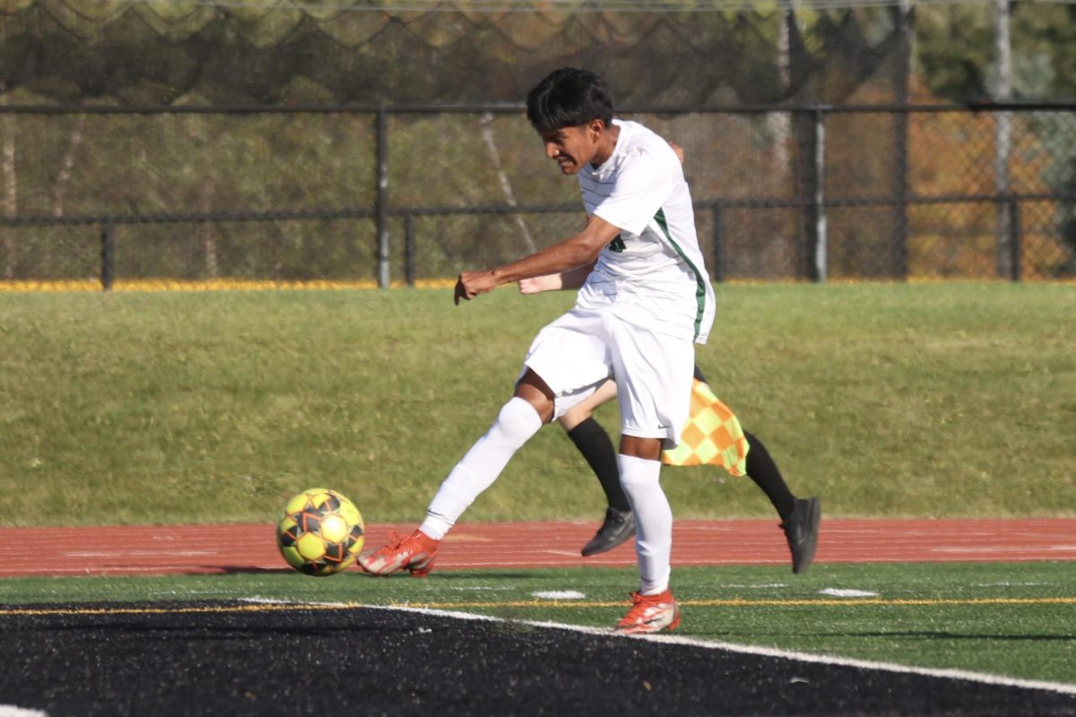 Freshman Alan Rivas kicks the ball to score a goal.