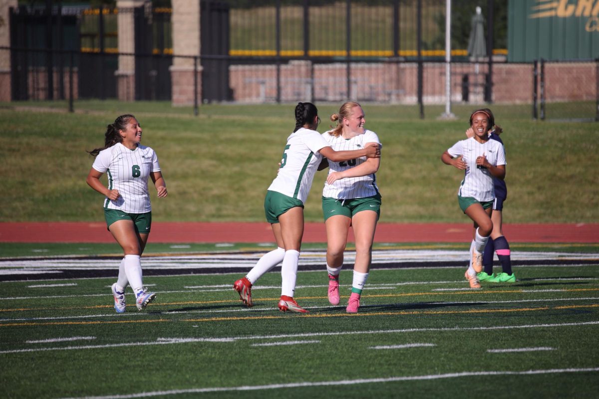 Sophomore Veronica Helma celebrates with teammates after scoring the first goal of the match. 