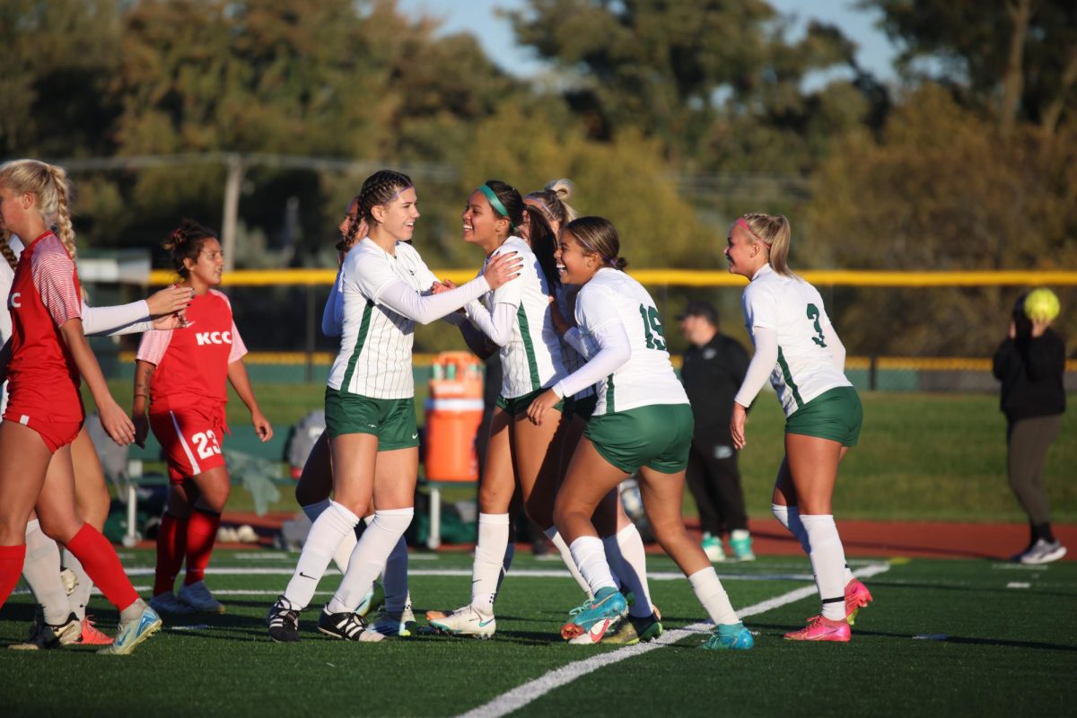 Berenice Marin celebrates after scoring a goal with her teammates.