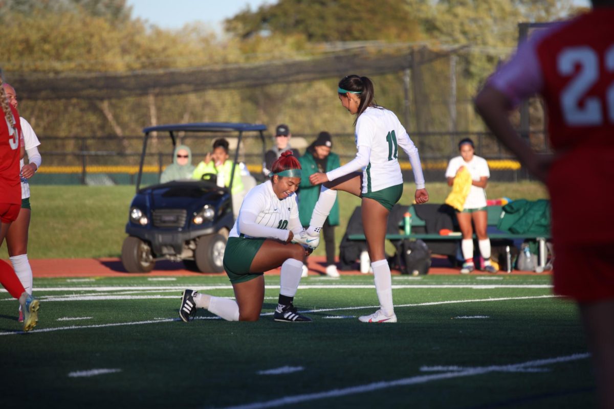 The COD women's soccer team celebrates after scoring a goal.