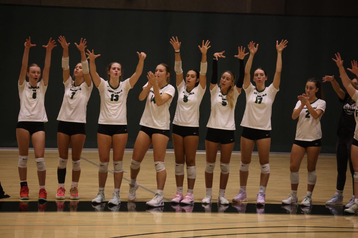 The COD women's volleyball team celebrates after scoring a point. 