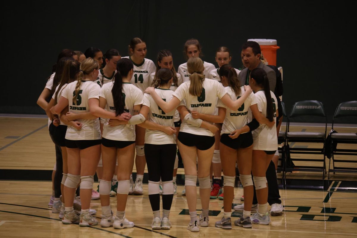 The COD women's volleyball team huddle during a timeout. 