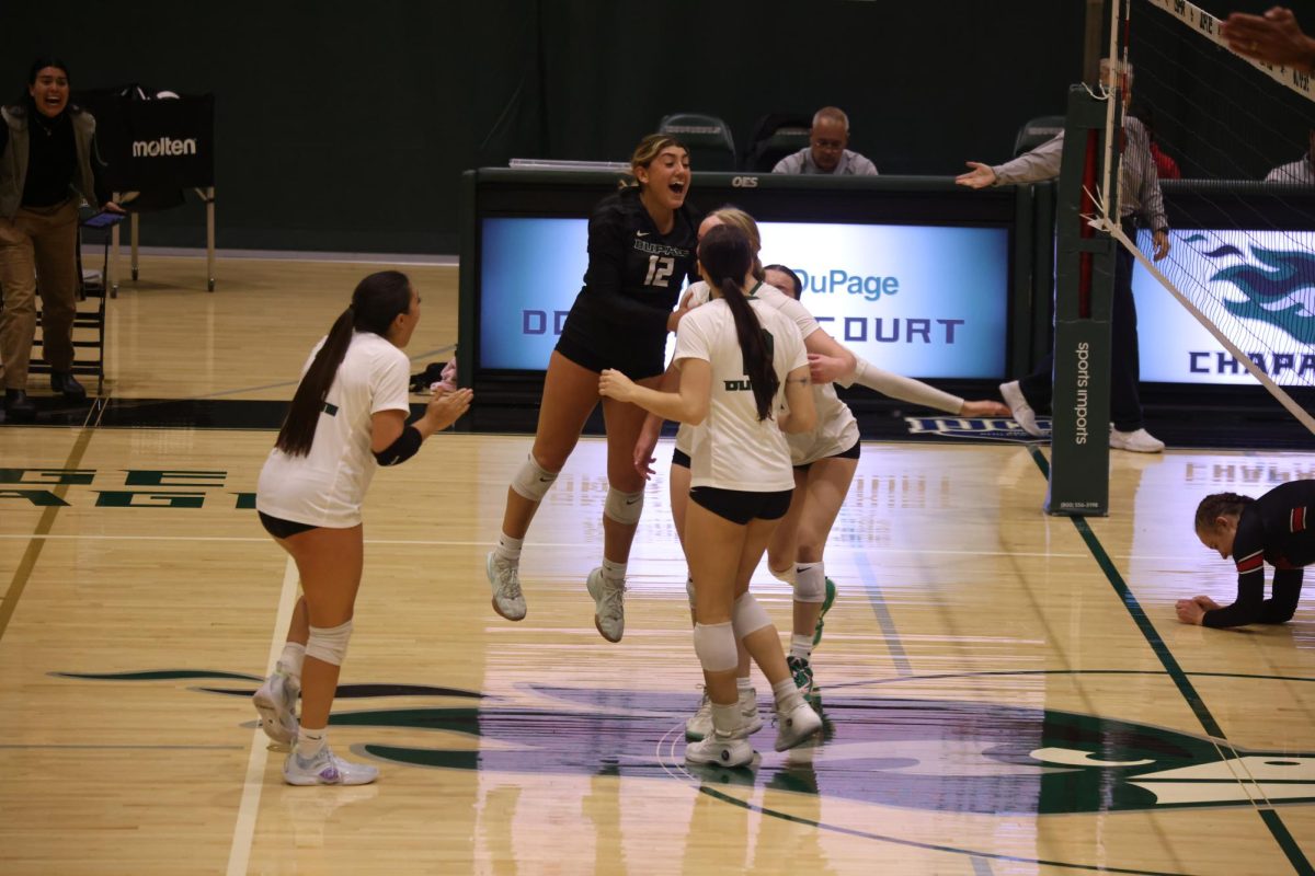 The COD women's volleyball team celebrates after scoring a point. 