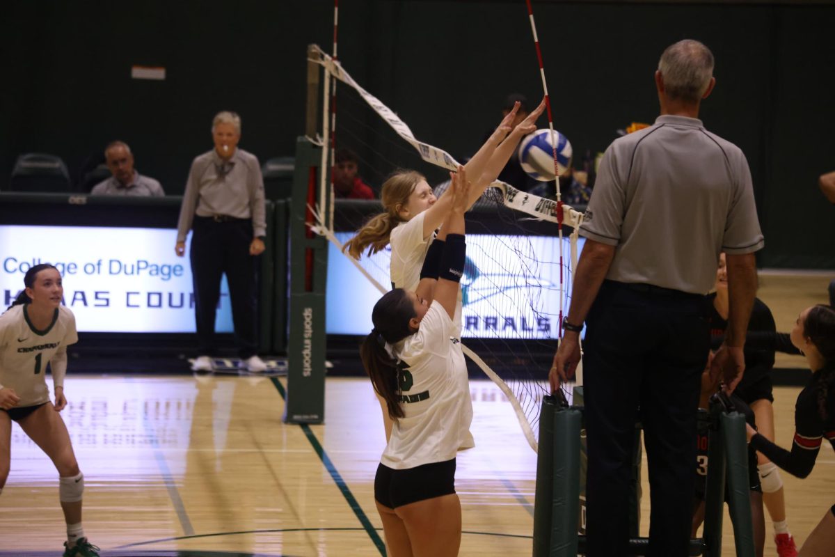 Josephine Becker and Ava Diaz block the ball. 