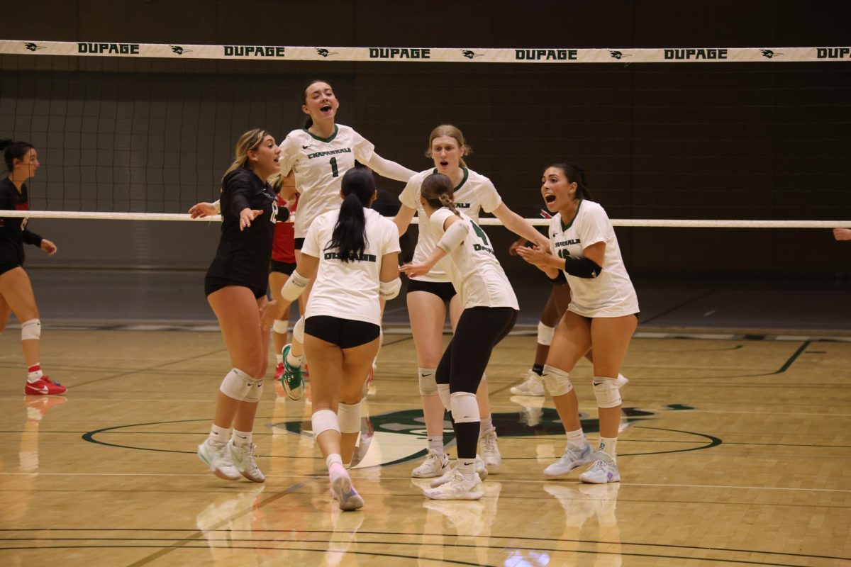 The COD women's volleyball team celebrates after scoring a point. 