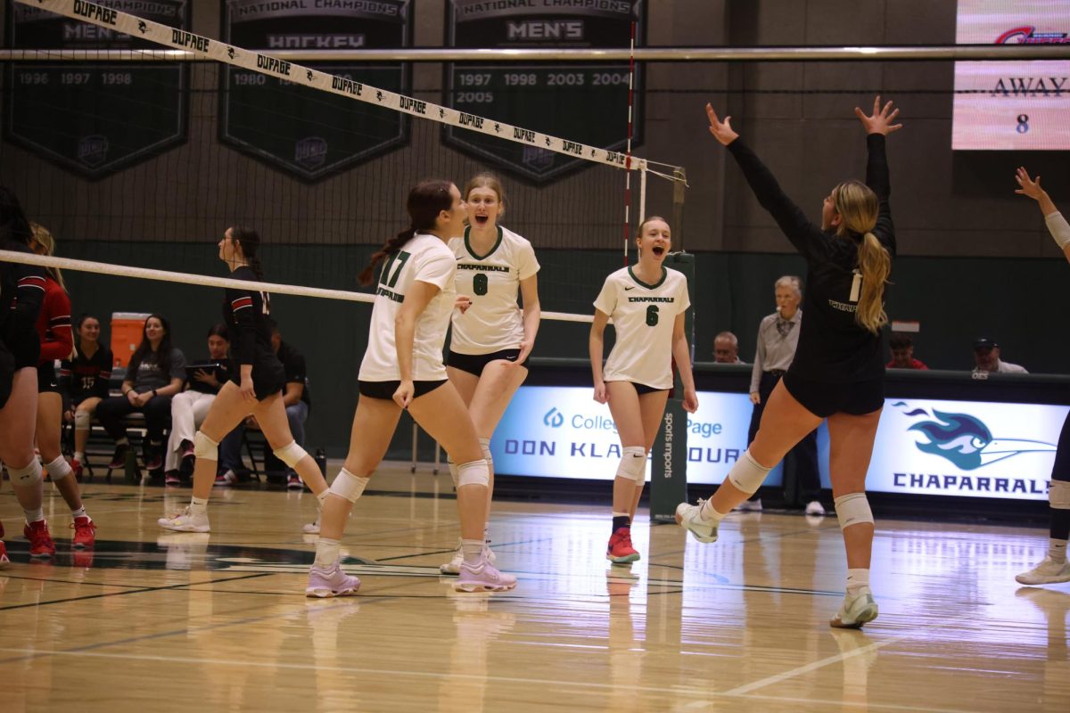 The COD women's volleyball team celebrates after scoring a point. 