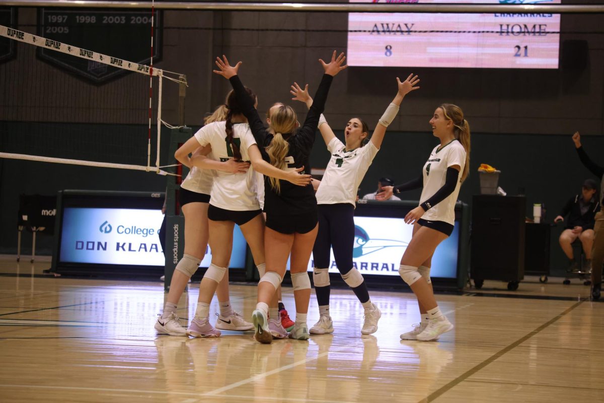 The COD women's volleyball team celebrates after scoring a point. 