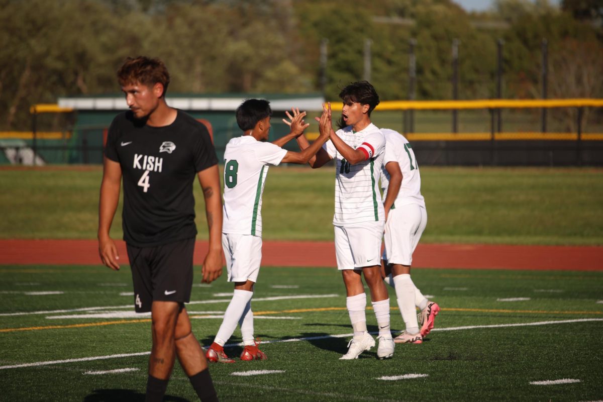 The COD soccer team celebrates after scoring a goal. 