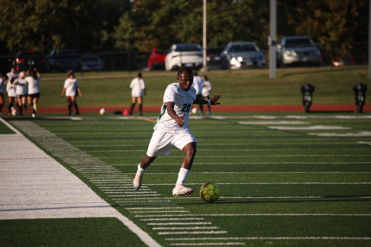 Freshman Benedict Okyere runs wih the ball. 