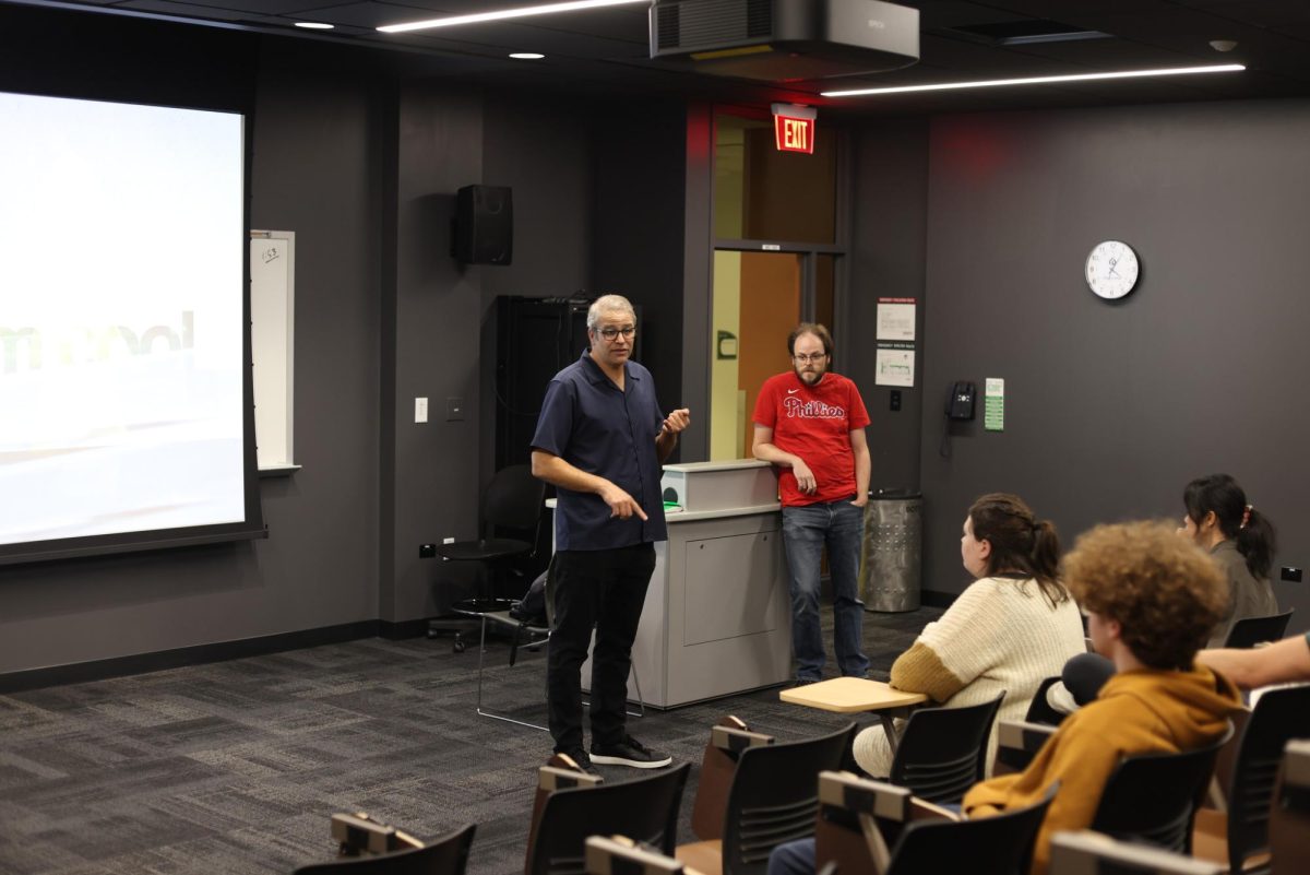 Professors Sam Mitrani (left) and Brian Brems (right) discussing "Medium Cool."