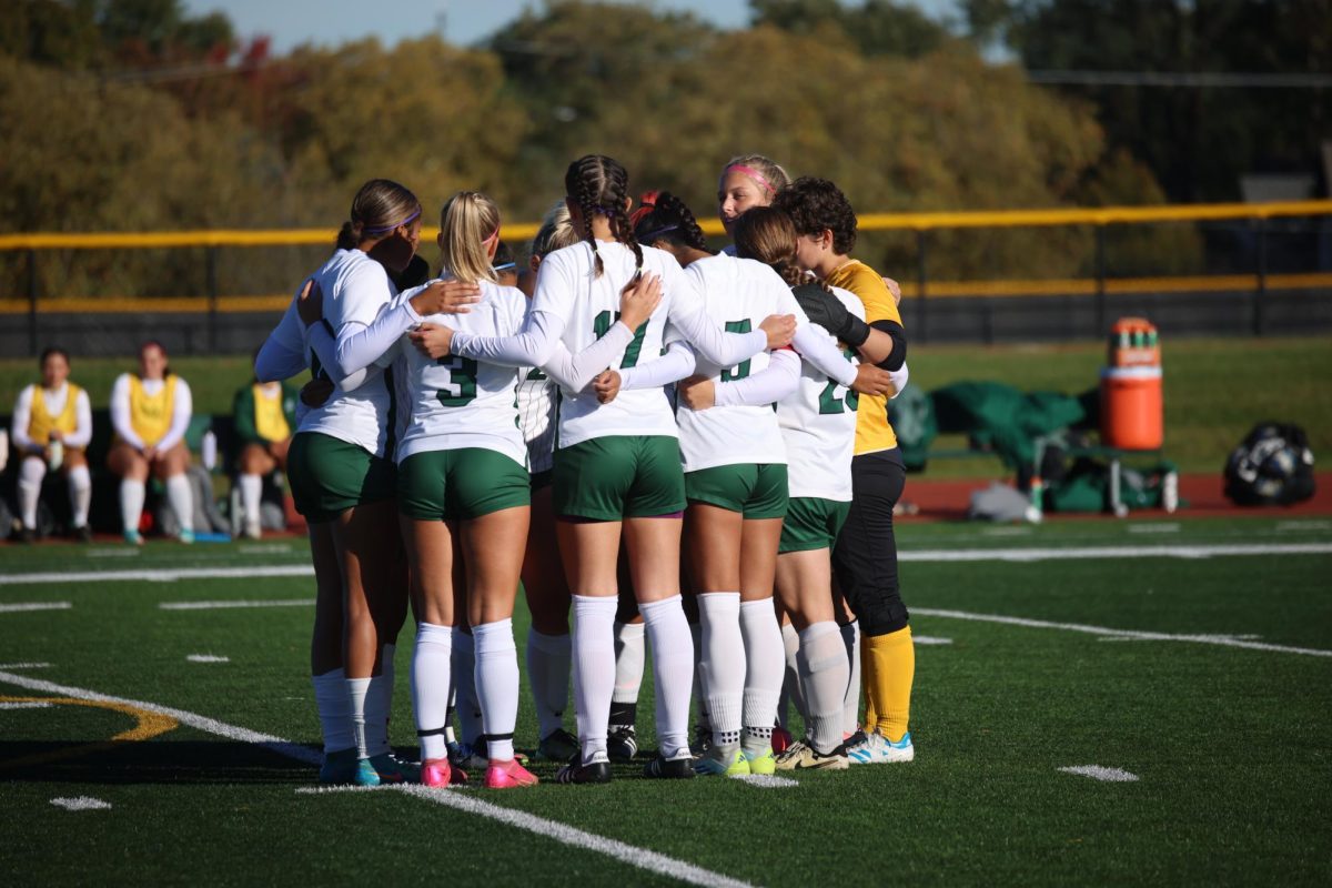 The COD women's soccer team huddles before the game. 