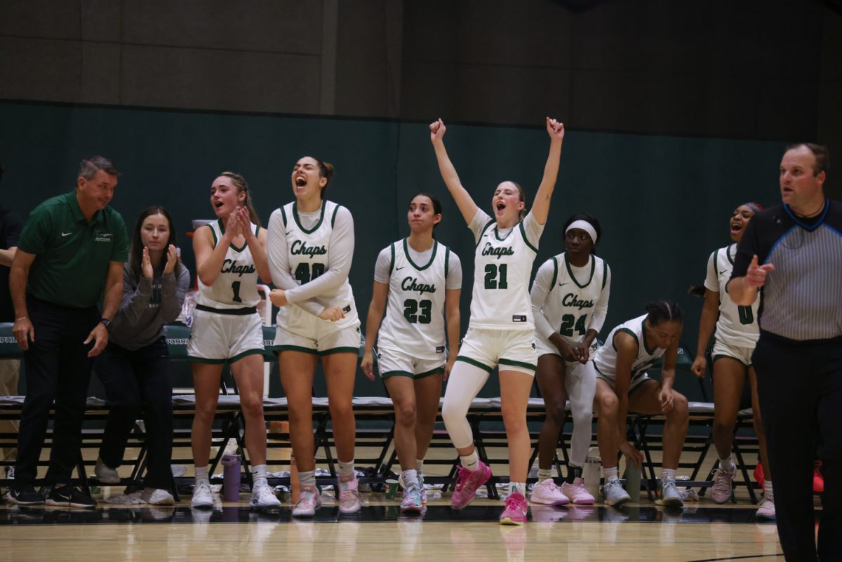 The COD women's basketball team cheers after scoring a point. 